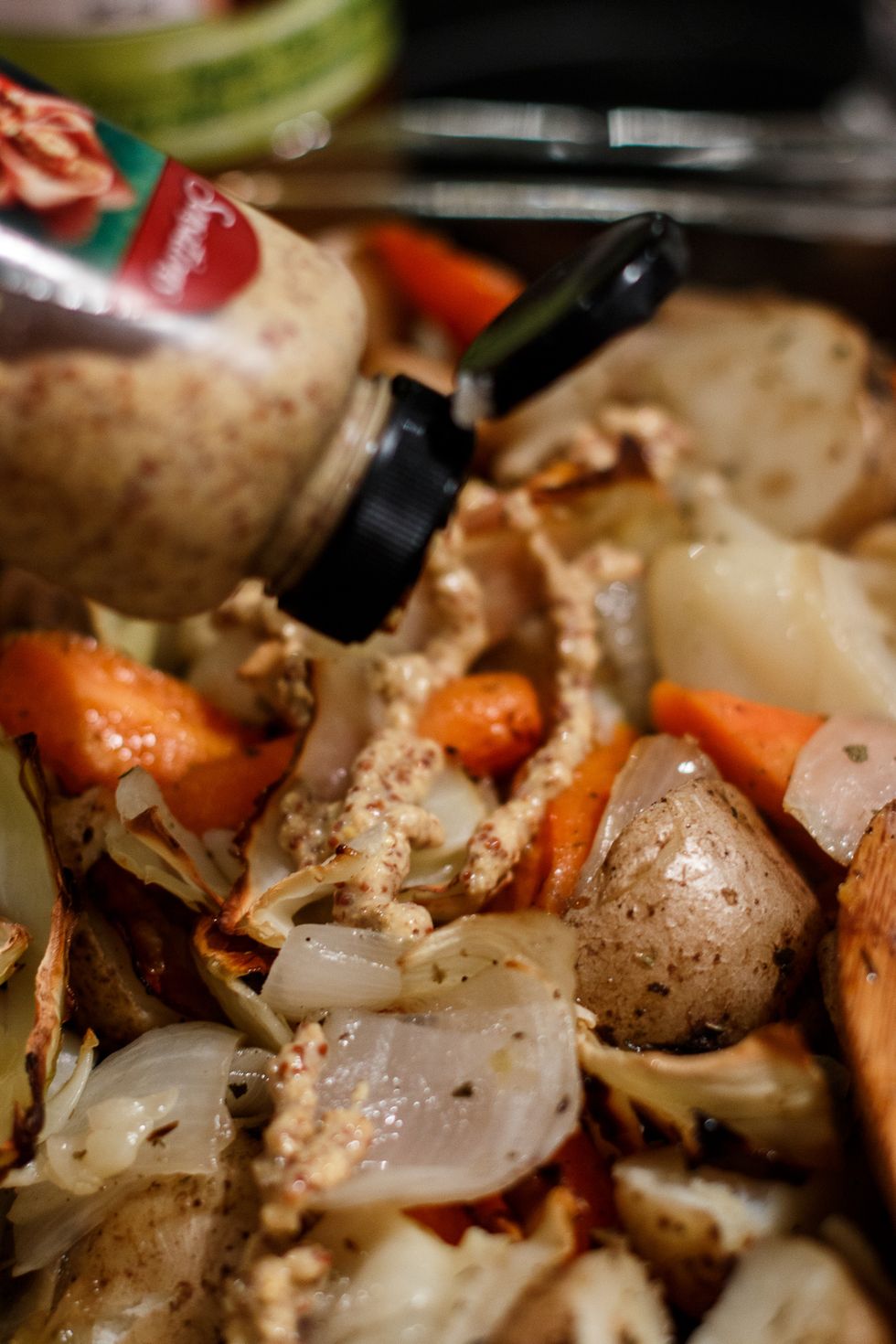 Once the potato and veggie mixture is cooked, add the apple cider vinegar and grainy dijon mustard.