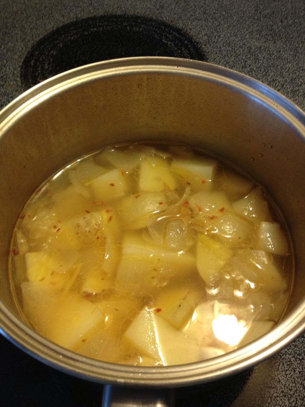 Once the potatoes are cooked, remove lid and continue to cook until much of the water is reduced.