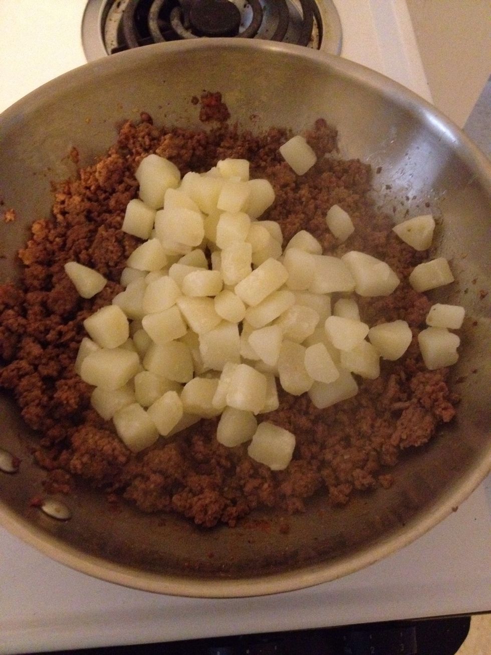 Once the potatoes are done add them to the browned meat