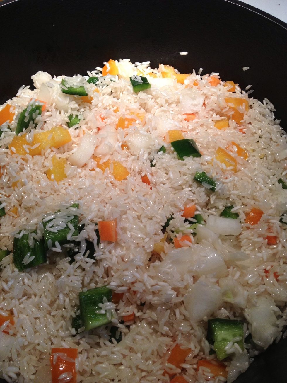 Once the rice has that toasted smell and a nice golden coloring you are ready to add chicken stock, tomato paste and salt. Stir mixture to combine.