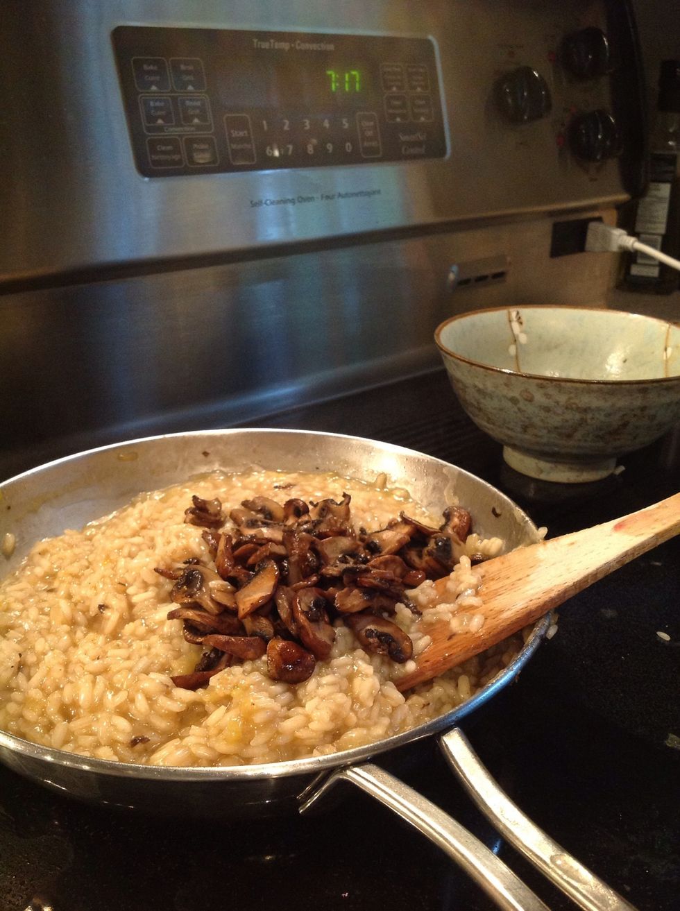 Once the rice is almost done, add the mushrooms for a few minutes. Add in grated Parmesan.