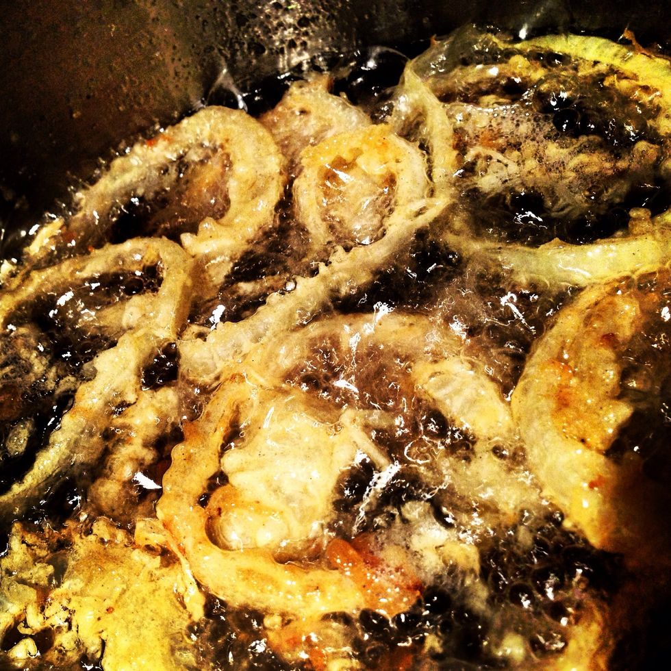 Once the rings have cooled and the oil dripped off, dip them one more time back into the batter and then back into the oil.