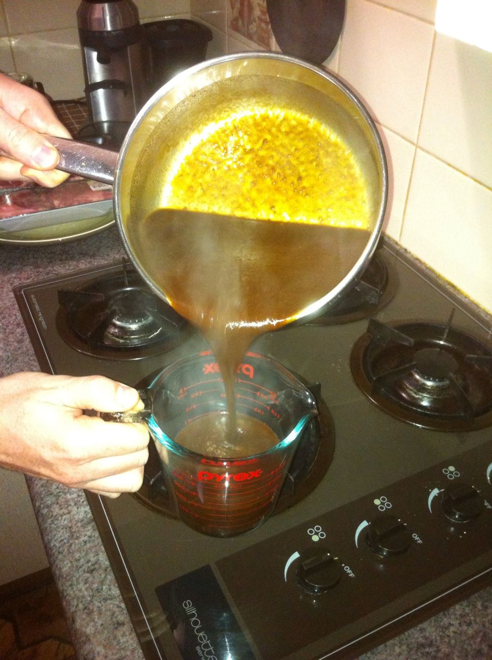 Once the sauce is the thickness you want pour it into a jug. This makes filling the jars much easier. By adding heated sauce to heated jars we should get a good seal and keep the mould out