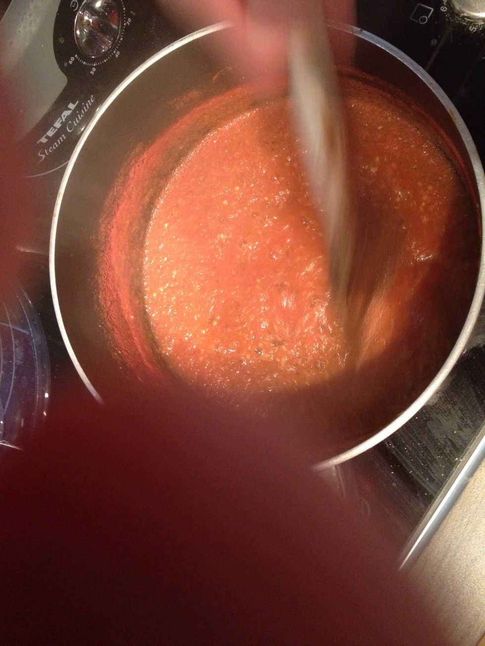 Once the sauce is thickened spread it on the pizza