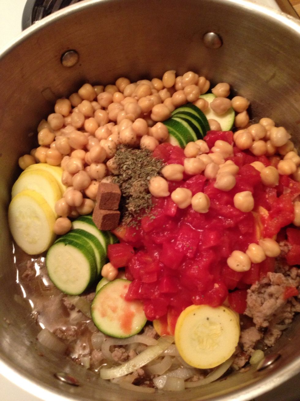 Once the sausage is cooked through, add all the remaining ingredients to the pot - sliced veggies, tomatoes (do not drain), garbanzos (drained), broth, basil, seasonings (I use 1 tsp garlic salt).