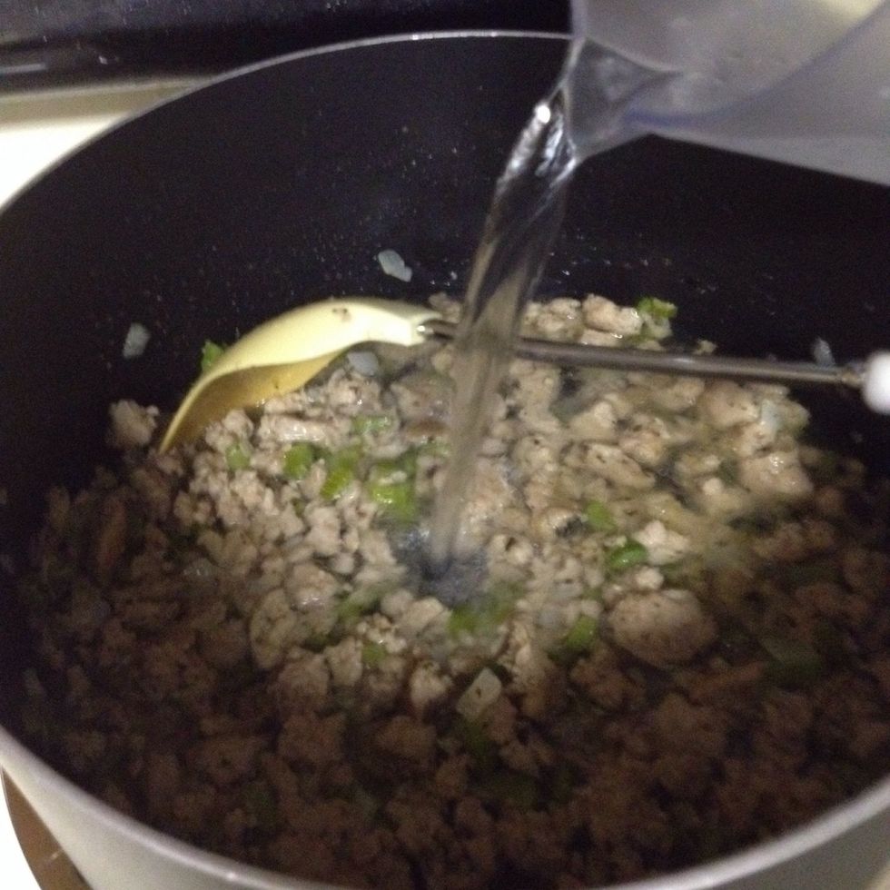 Once the sausage is cooked through, pour in the chicken broth (or in my case, water & bullion).