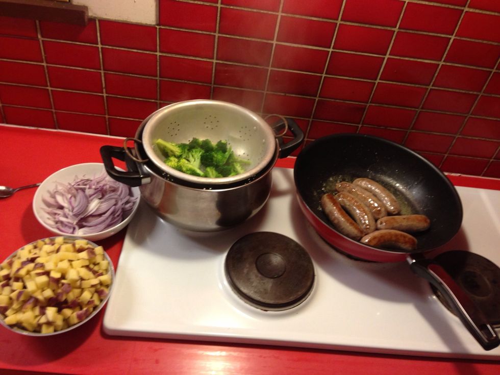 Once the sausages are cooked, remove from the pan and keep warm. Then stirfry the salami, onion and garlic in the same pan over a medium heat till soft. Meanwhile, steam the Brocolli.