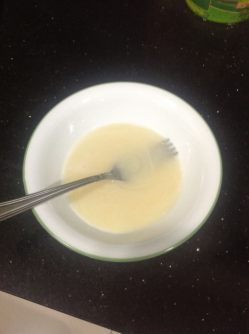 Once the second rising is done, make your glaze. Just put the icing sugar, milk, golden/corn syrup & vanilla in a bowl and mix it with a fork.