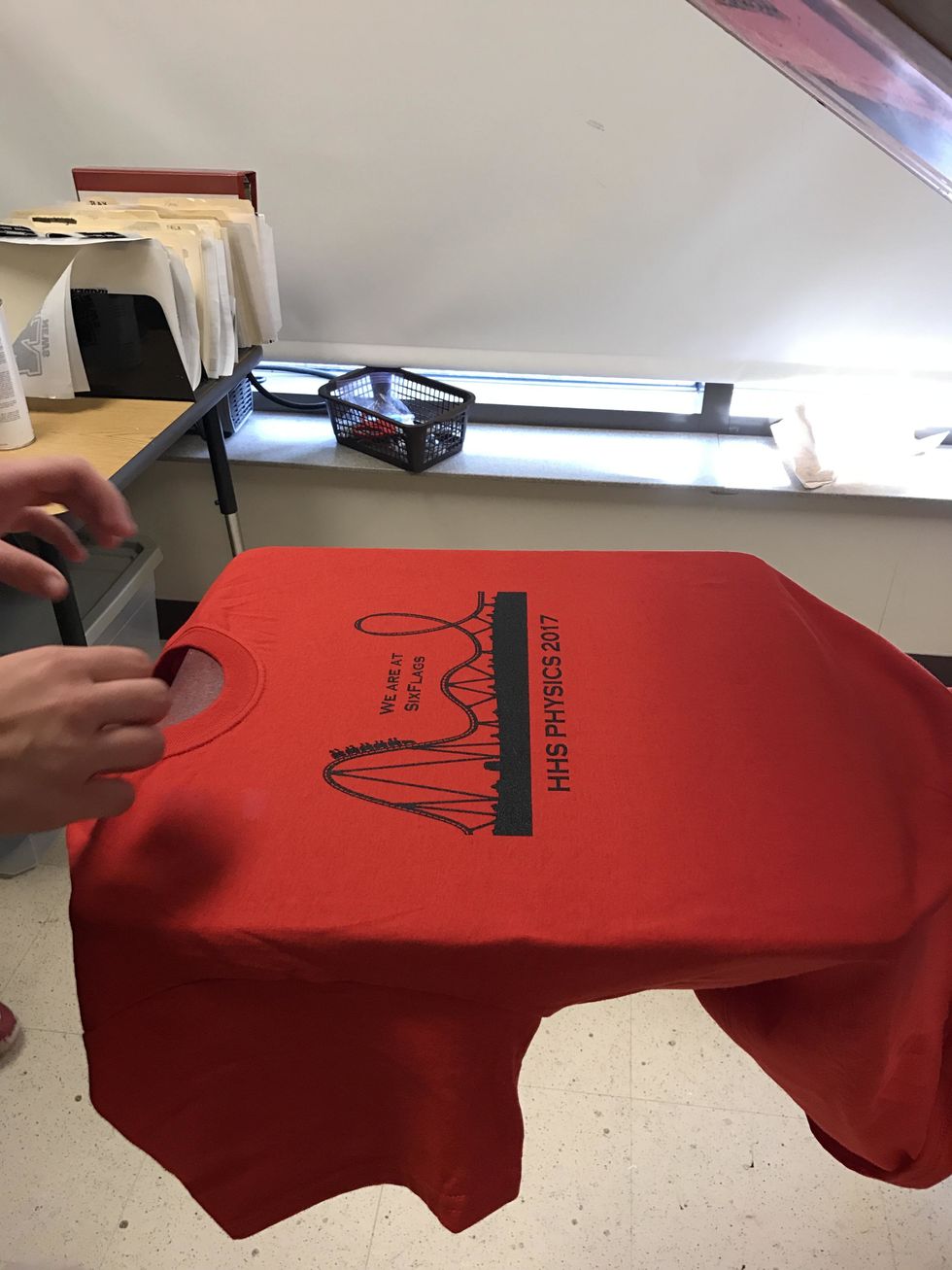 Once the shirt is complete with the final layer of ink, do not put it under the heat lamp. Instead, carefully take the shirt off and take it straight to the dryer.