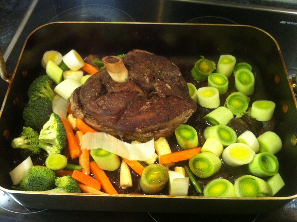 Once the slow roasted leg is three quarters done - add the vegetable selection - leeks , carrots , bracolli  or any other vegetable that you desire