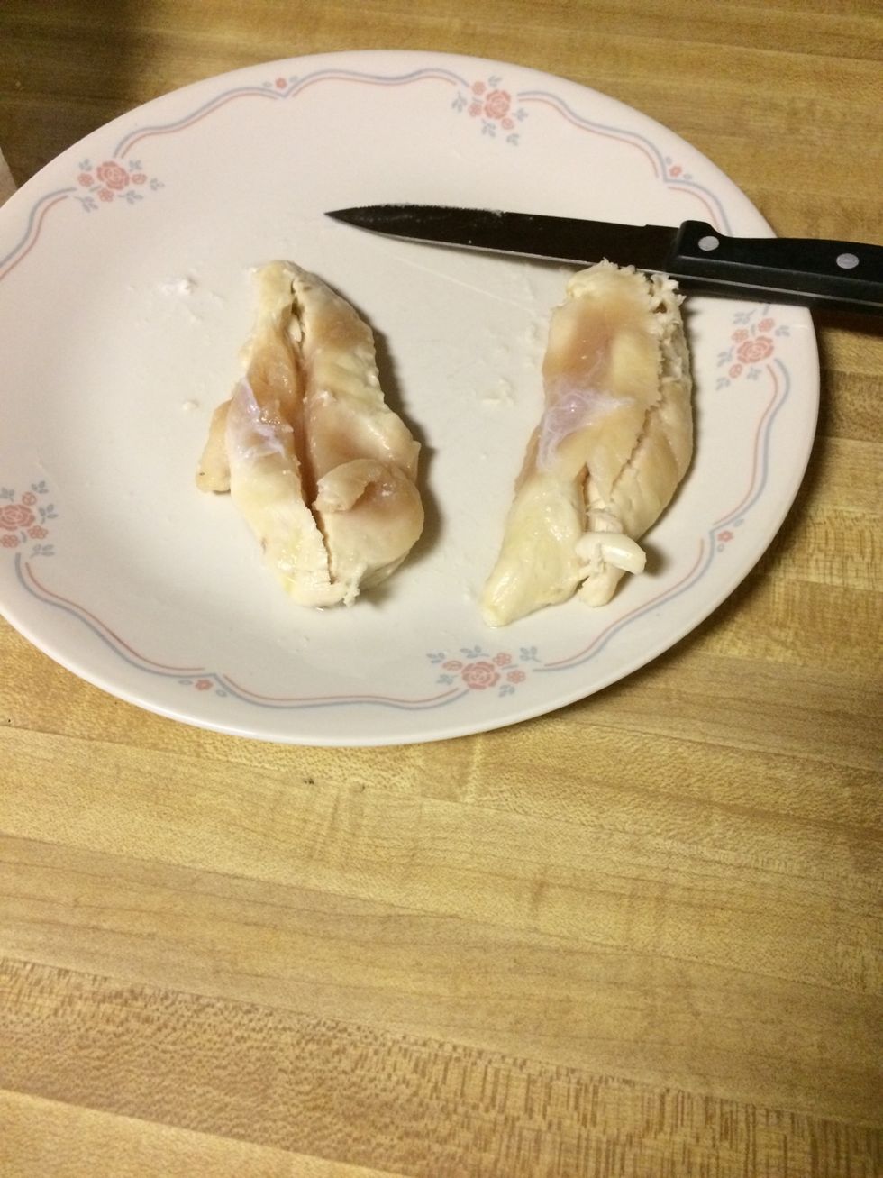 Once the spinach is wilted, cut the chicken breast either from the side or on the top. It's what you prefer. I did both I like cutting it from the top personally.