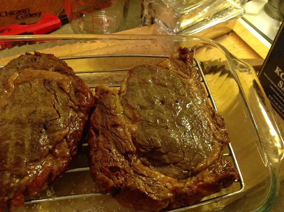 Once the steaks reach 115 degrees, pull them out of the grill. Then, pat them dry and brush on rendered beef fat or vegetable oil.