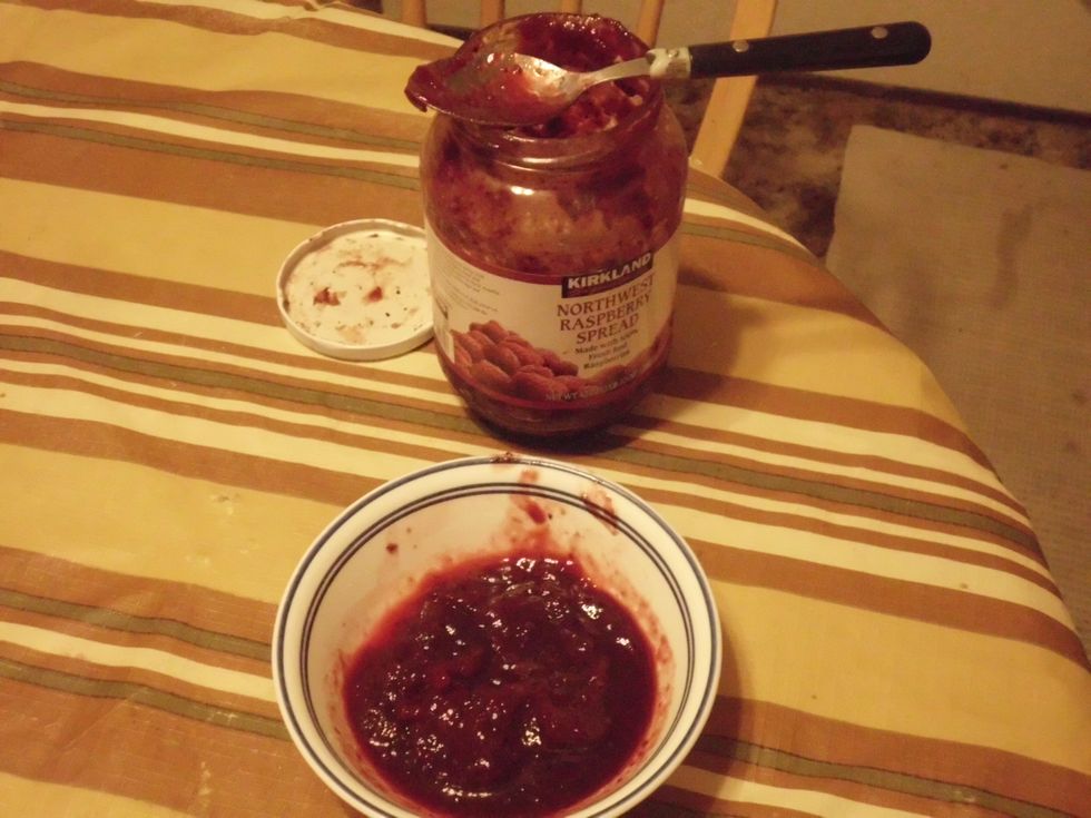 Once the strawberries are on, the next step is take the strawberry jelly out, and put into a bowl. "Now you do not need to use strawberry jelly for this step, just about any berry jelly will do".