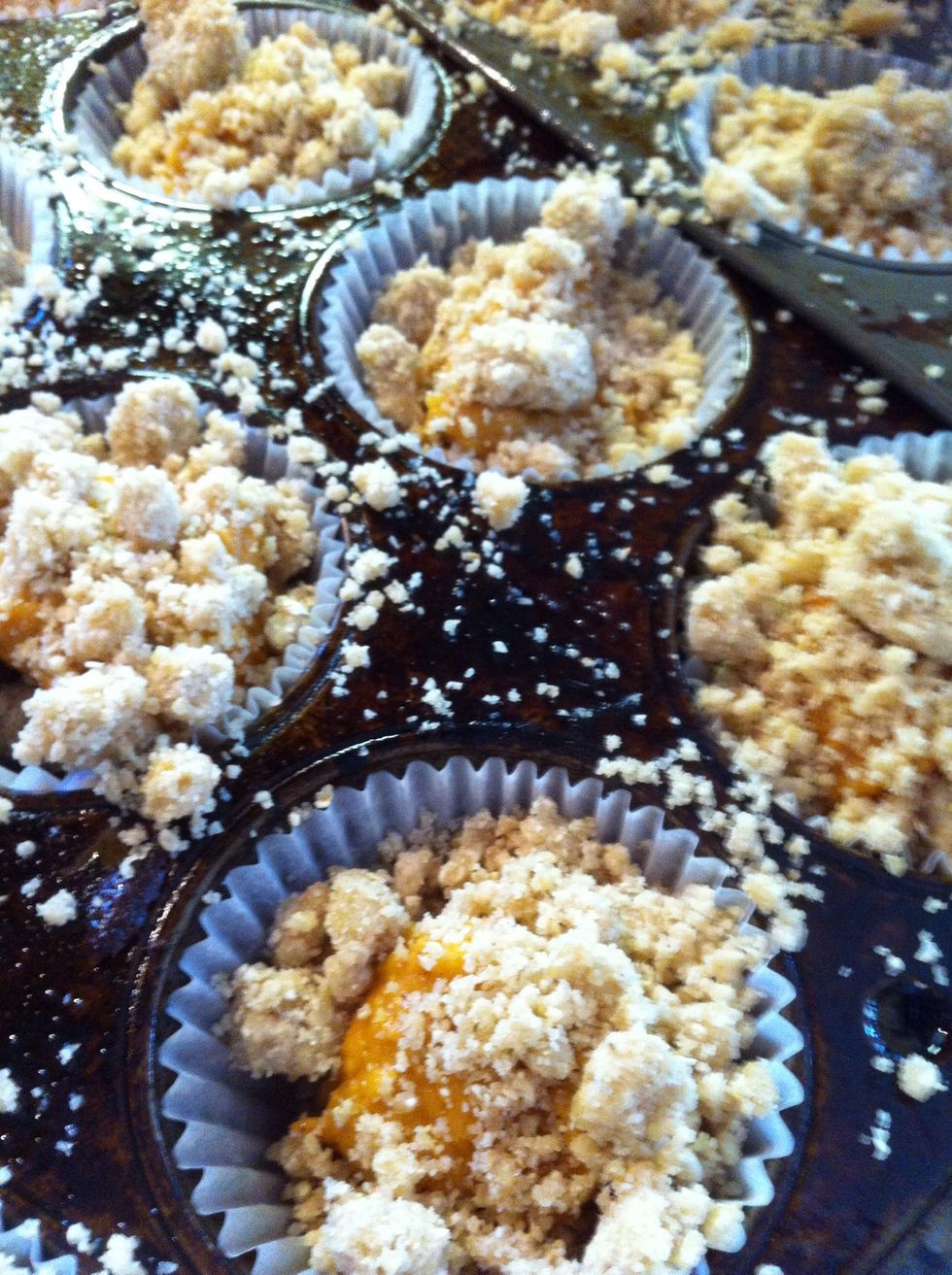 Once the strudel is mixed, lastly add an egg. It will hold the crumble better. Heap that atop each muffin. This crumble makes a lot, what you don't use place in freezer bag and store for another time