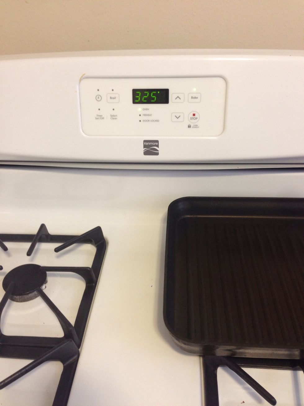 Once the turkey is defrosted enough, preheat the oven to 325 Fahrenheit.