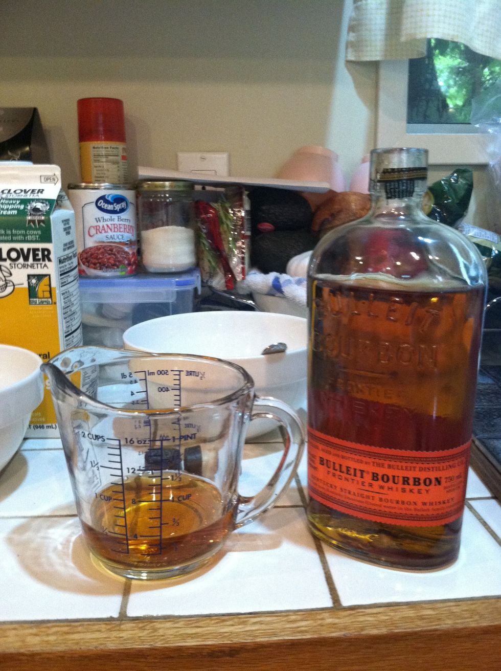 Once the veggies are done, add heated broth, cooked neck and giblets, bourbon, bay and sage leaves to the pot. The bourbon must be from Kentucky. Do not use whisky or scotch.