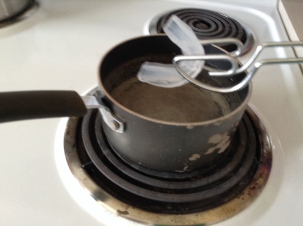 once the water is slightly boiling, place the mouth guard in the pot for about 20-30 seconds.