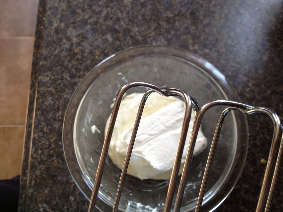 Once the white chocolate is no longer warm, add to the bowl the 4 oz. of cream cheese and best together until smooth.