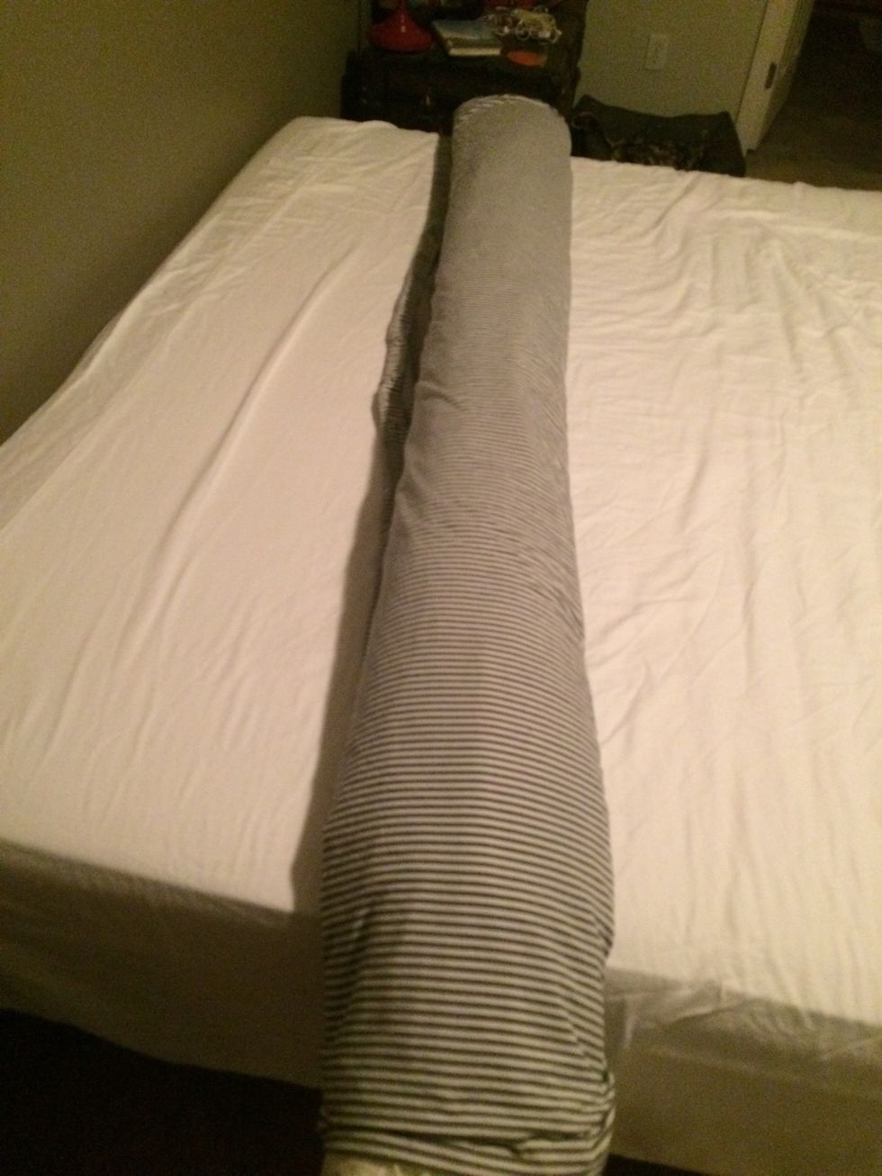 Once the whole duvet and cover are rolled up together, open the cover onto itself. (Think that little lip on those plastic sandwich bags) Fold the opening over the roll and start unrolling.