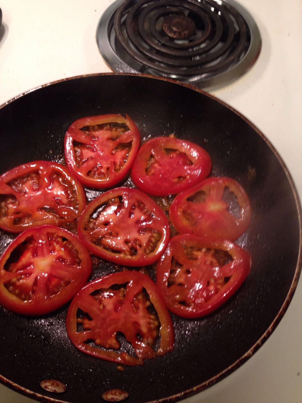 Once the wine has reduced a bit, add the tomato slices. Sear for about 2 mins on one side for a little caramelized flavor.