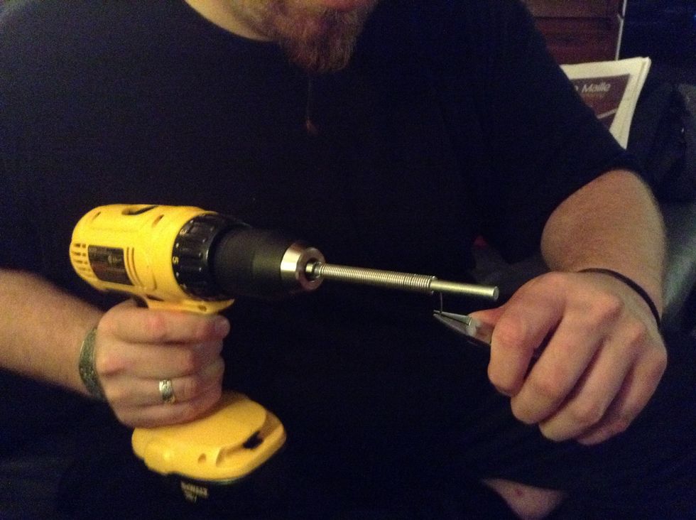 Once the wire has reached the end of the rod, release the trigger to stop the coiling process.