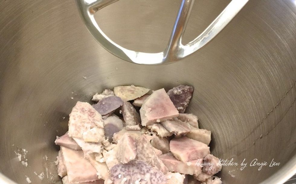 Once the yam is cooked, quickly transfer it to a stand mixing bowl with a K hook attached.
