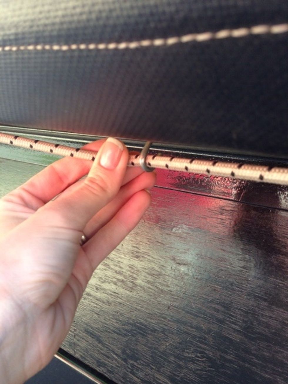 Once the yellow strap is removed, unbungee the float tarp from the entire bottom of the float.