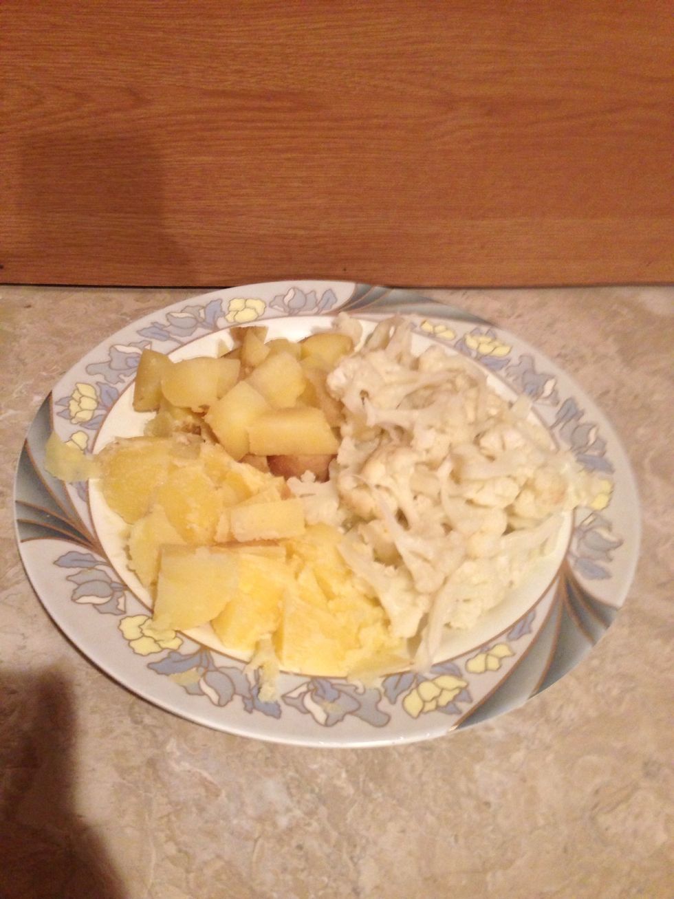 Once they are cooked . Cut the potato into small cubes and the cauliflower into small pieces .