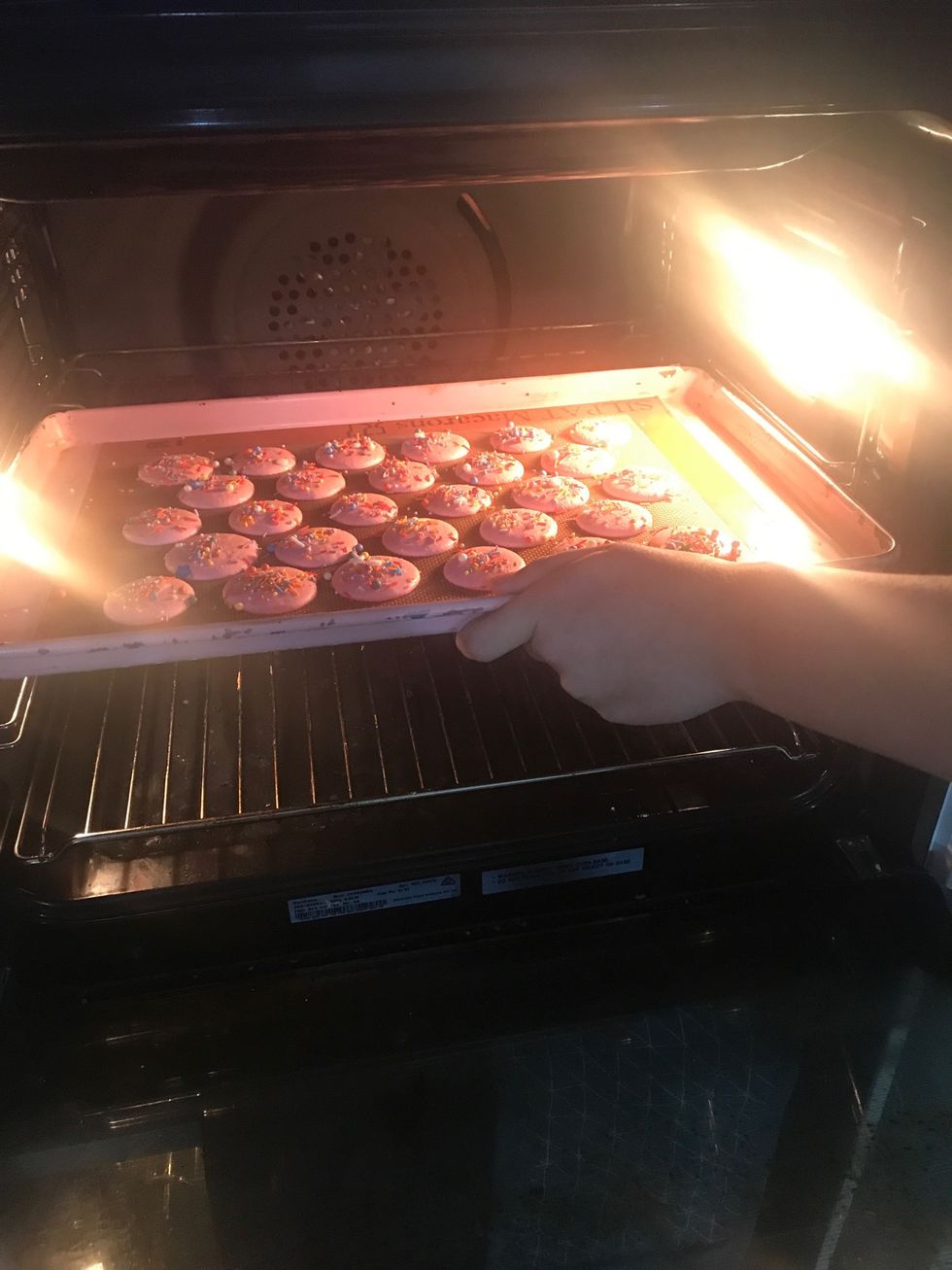 Once they dry, bake the macarons on the middle rack in the over for about 12-14 minutes. You can test to see if they are done by wiggling the top of the shell. If it doesn't move, it's done baking.
