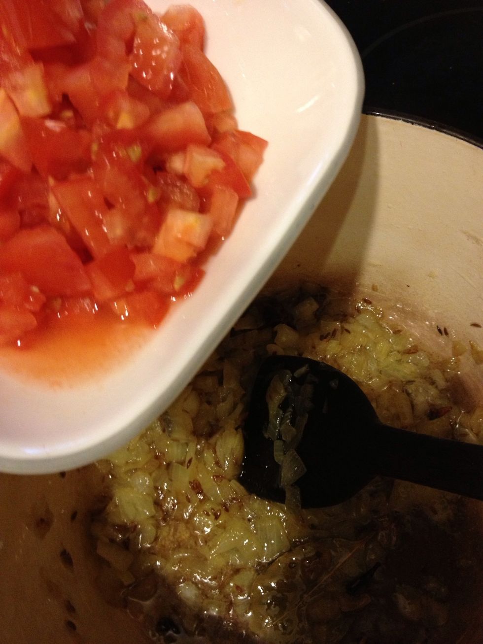 Once they have browned add your tomatoes and turmeric like 1/2 tsp and 1 tsp salt