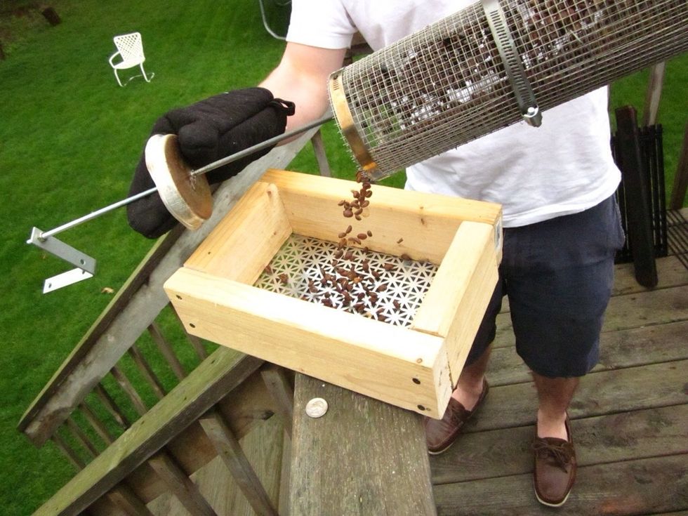 Once they have reached their time or are the desired color, remove from grill and dump into sifter. Sifter made from small grate and 2" x 4"s.