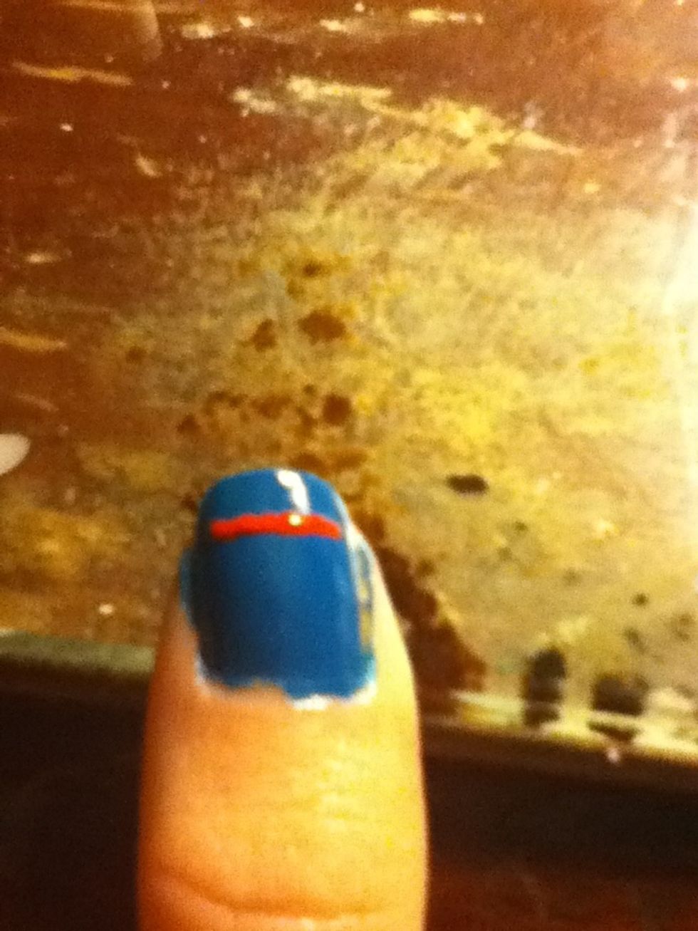 Once they're dry, start to make the super man sign. Start by making a straight line going across most of your nail.