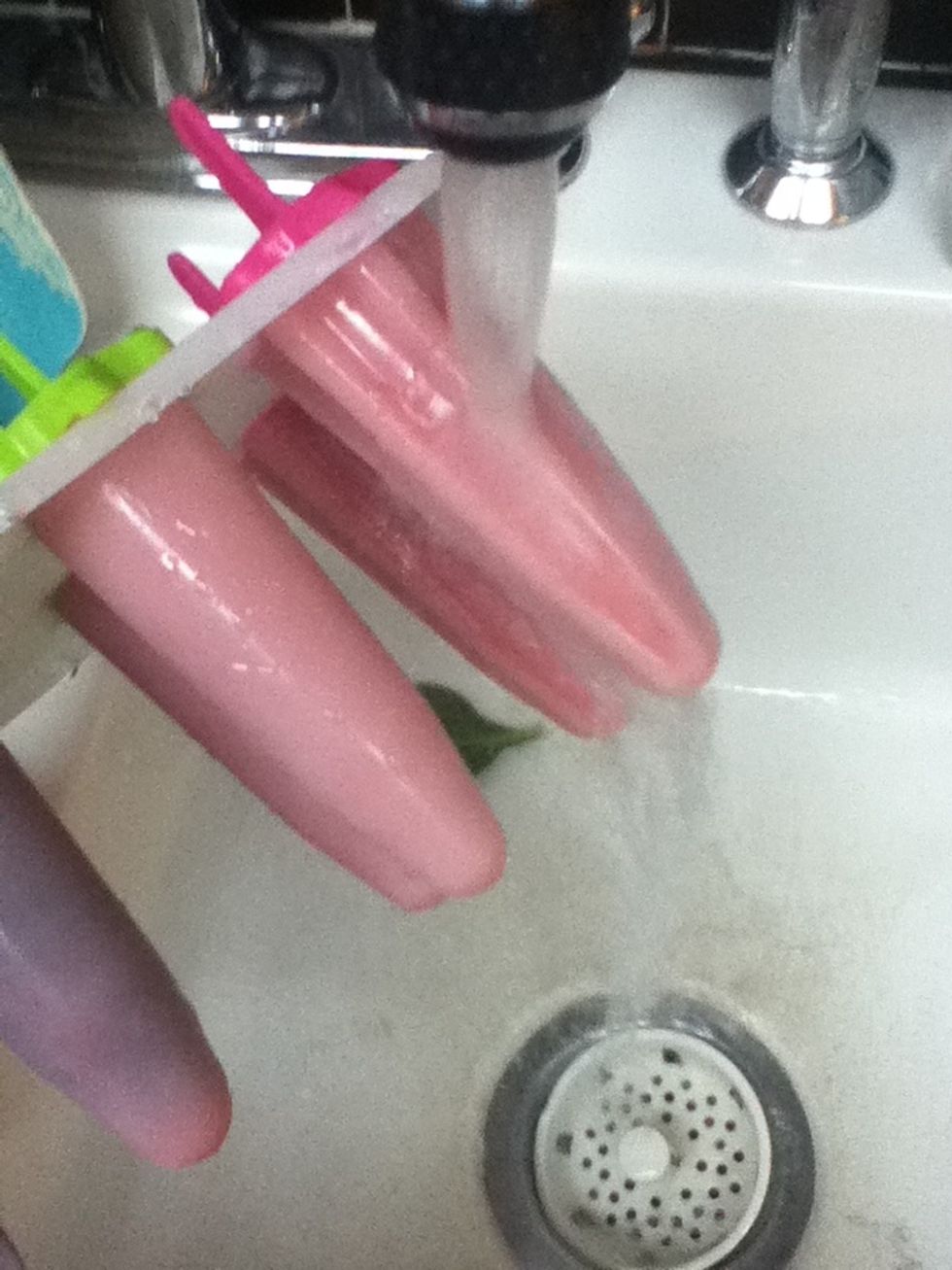 Once they're frozen, run them under hot water if they are stuck in the molds. This will make them slide out easily.