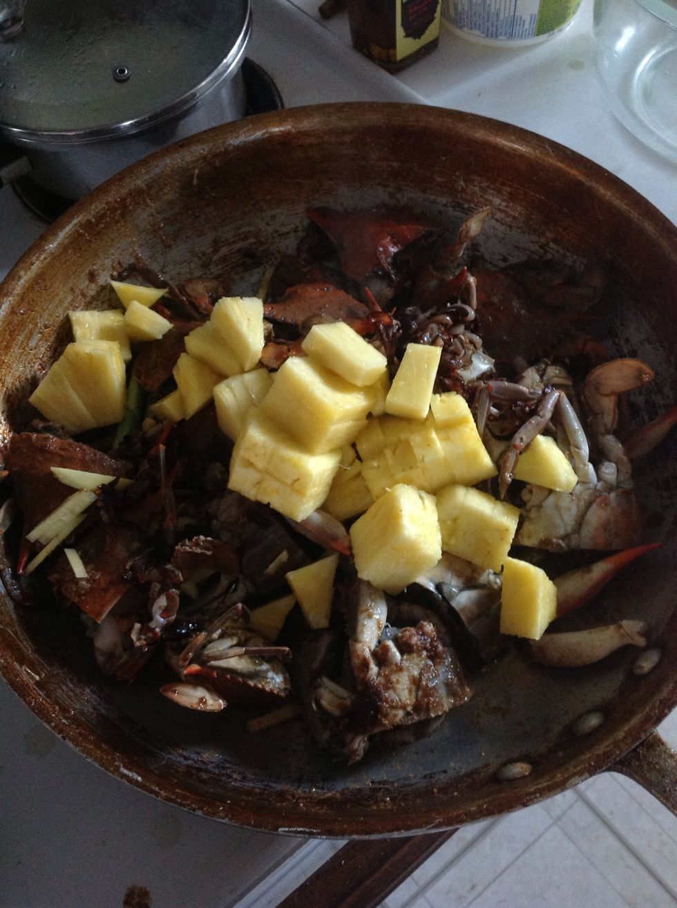 Once they've been cooking for a minute or so, add the pineapple and toss again to coat.