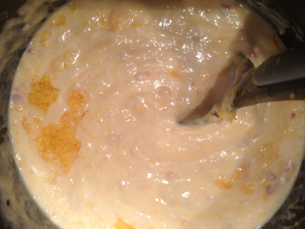 Once thickened, turn off the heat and add the cheeses, stirring until incorporated. Add salt and pepper to taste. Add a bit of paprika for color if desired.