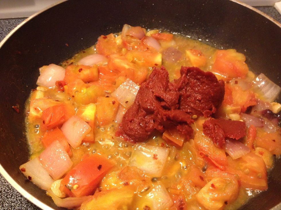 Once tomatoes soften, add the tomato paste.