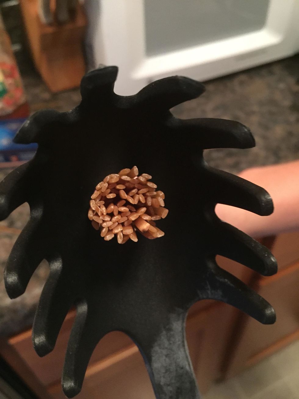 Once water is boiling, carefully add spaghetti noodles to the large pot. Tip: the hole in a spaghetti spoon can be used to measure a serving size of dry noodles