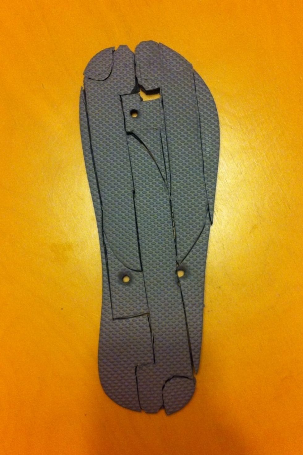 Once you align all three paper templates, one from the heel and the other two from the toe, use a pen or the x-acto knife to trace them, then cut the basic shapes out completely with the scissors.