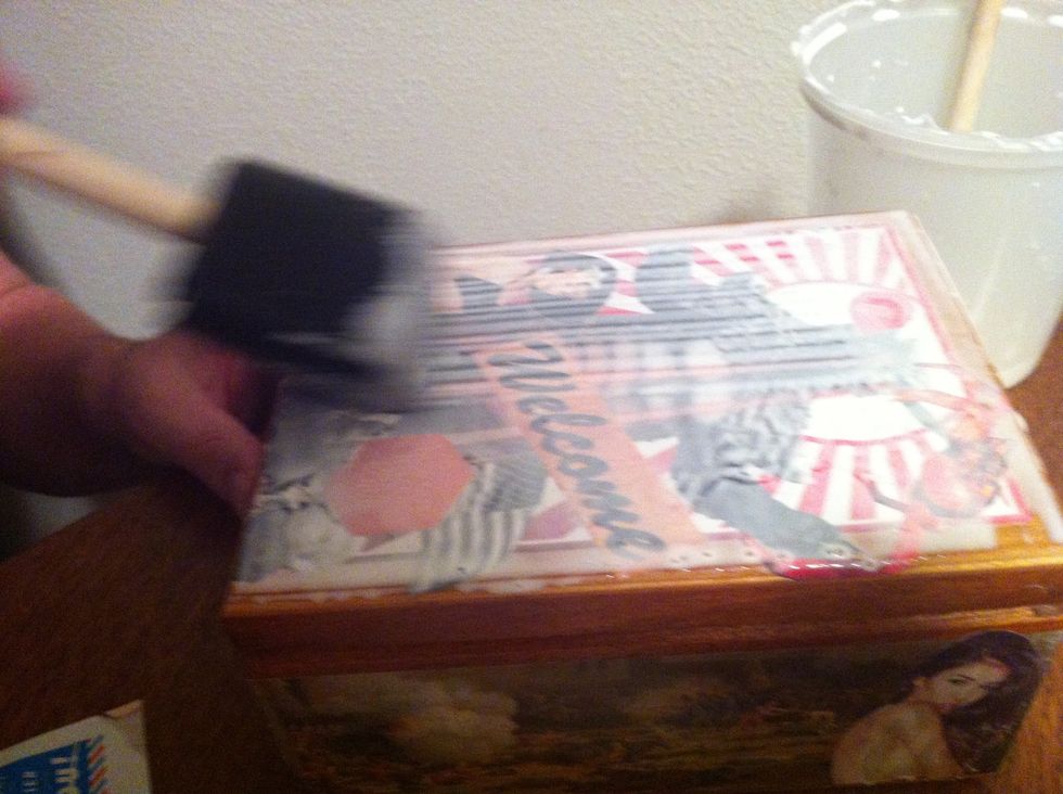 Once you are done applying all your clippings take your large foam brush and apply a layer of the glue solution over the whole box.
