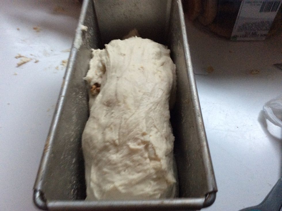 Once you are done kneading, place in bread tin.