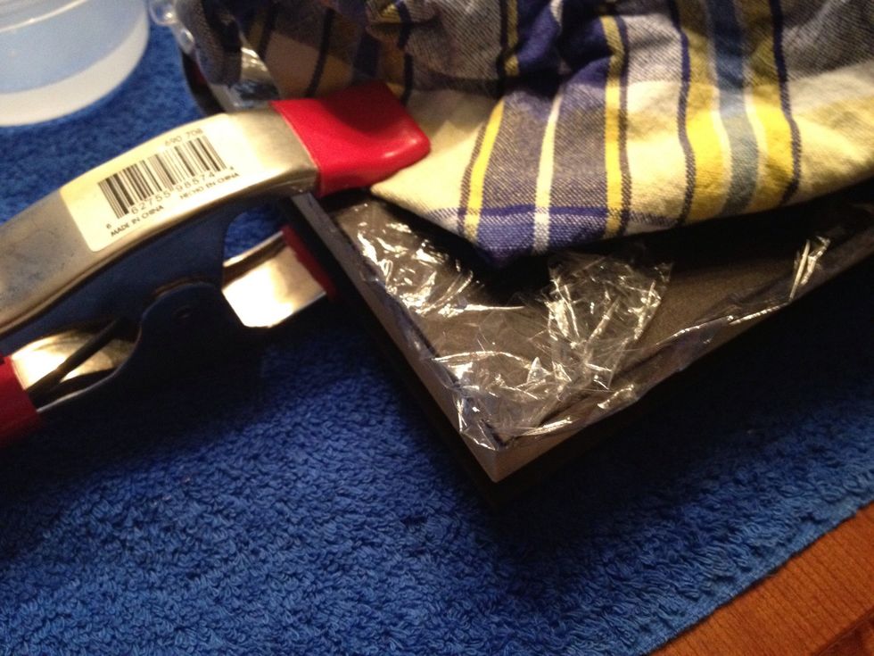 Once you are done painting, add a cloth around the book and place the clamps on all three sides. NOTE: The cloth is to protect the cover from having clamp marks.