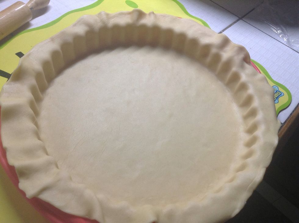 Once you are done, you will have something like this. You will have extra dough on all the sides. Some people like cutting it with the help of scissors. Personally i like doing two layers on the sides