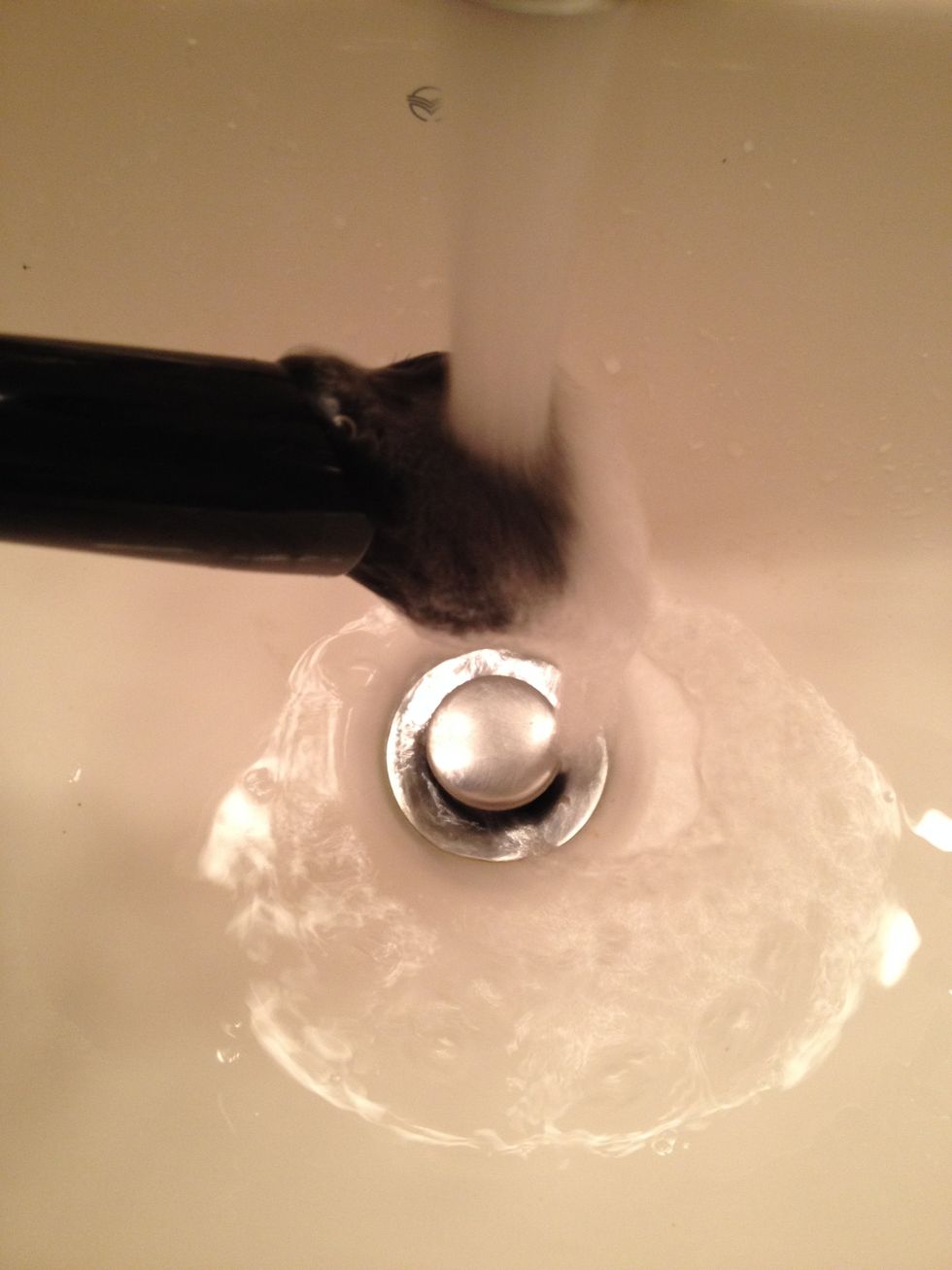 Once you are satisfied with the cleanliness of your brush, angle it DOWNWARD into a stream of LUKEWARM water.  Slowly rotate the brush to saturate with clean water and rinse out the soap completely.