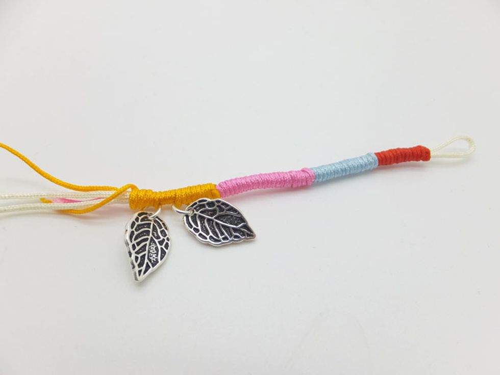Once you braided half of the bracelet, add on the 925 sterling silver leaves on.