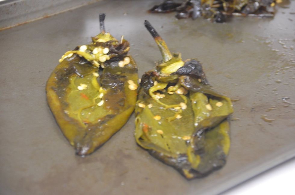 Once you broil them you will see a think black layer on top.. Peel that and split the pepper into half and remove the seeds from inside. (As seen above)