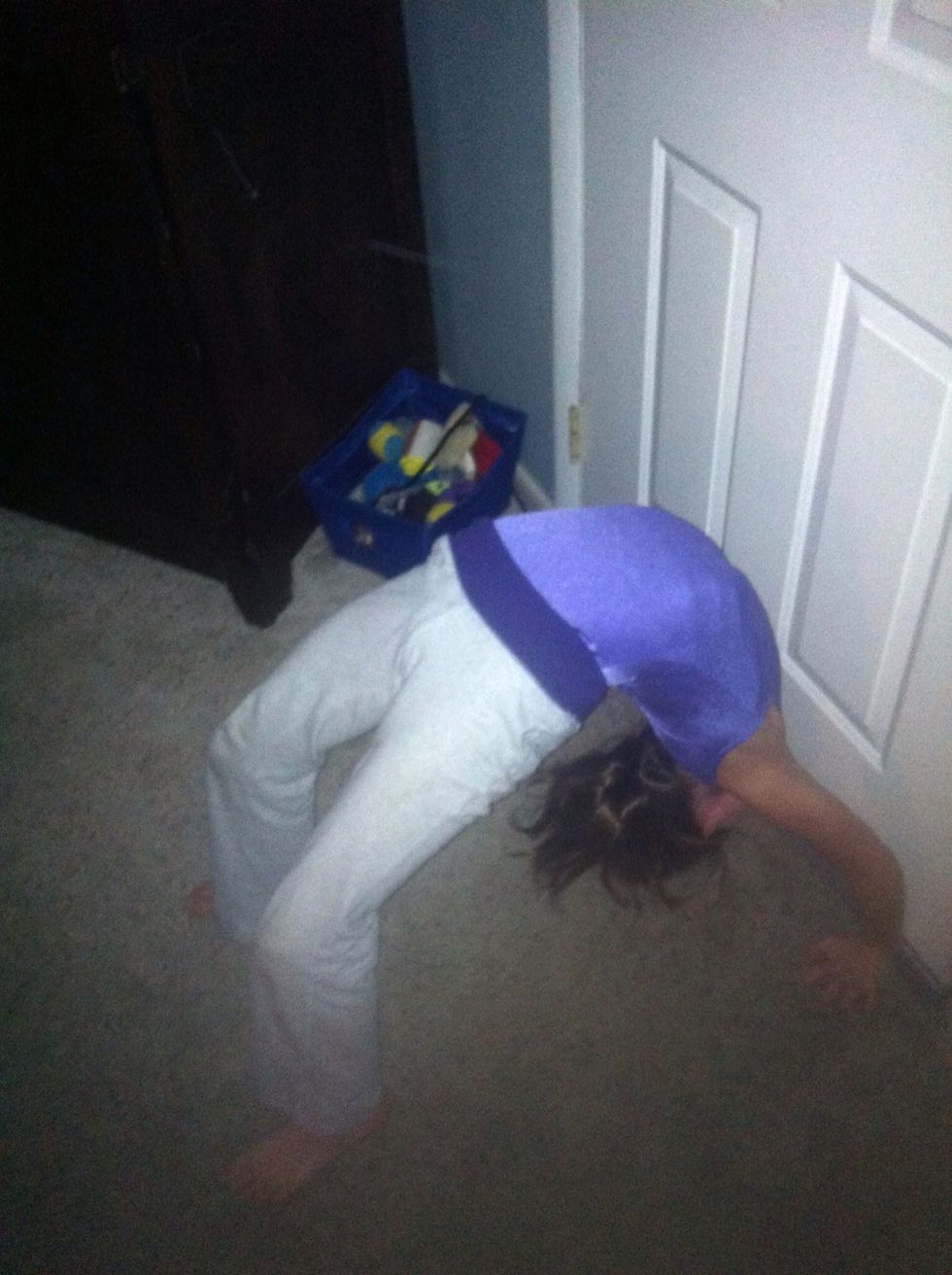 Once you completely reach the ground, stay for 10 seconds to build strength. Keep your legs shoulder width apart. At this point, you can either walk back up the wall, standing up, or just collapse.