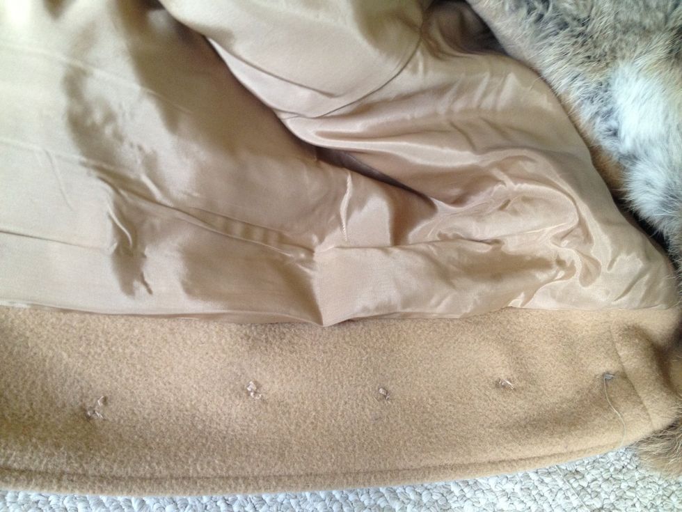 Once you feel the button is tight and secure, come back through the hole and tie a not on the inside of the garment (same side as first knot).