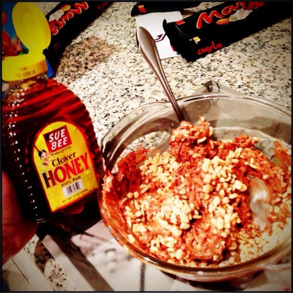 Once you feel there's an approx equal ratio of Rice Krispies to Chocolate, this is where you add honey. Add 4-8 tablespoons of honey to the mixture and mix. You will notice a slight shine in the mix.