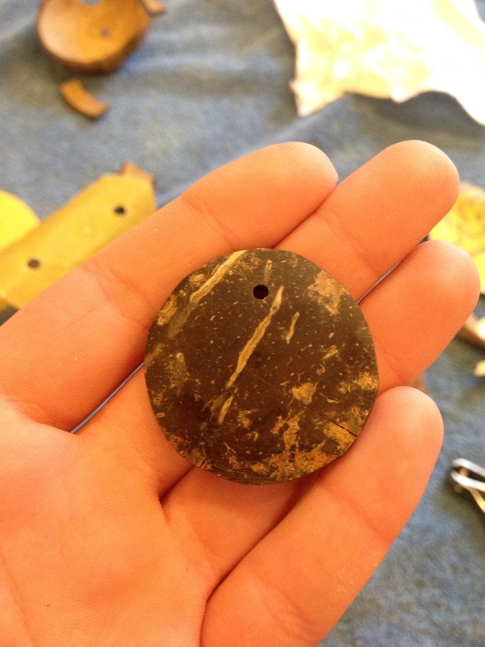 Once you finish shaping it, smooth the edges with the fine grit sandpaper. Drill a hole about three millimeters away from the edge. I used a 1.6 mm drill bit, but feel free to change the bit size.