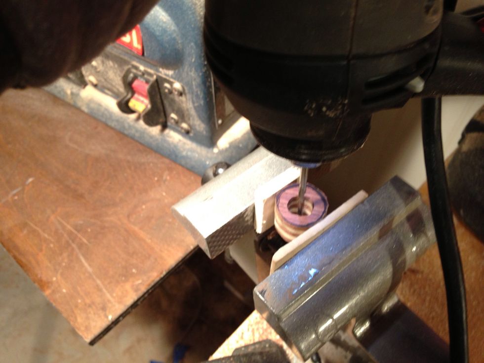 Once you get a large enough hole switch back to Dremel with small sanding disk to smooth out the inside of the ring.